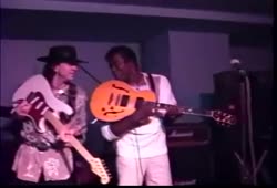 Buddy Guy and Stevie Ray Vaughan sharing stage in 1989